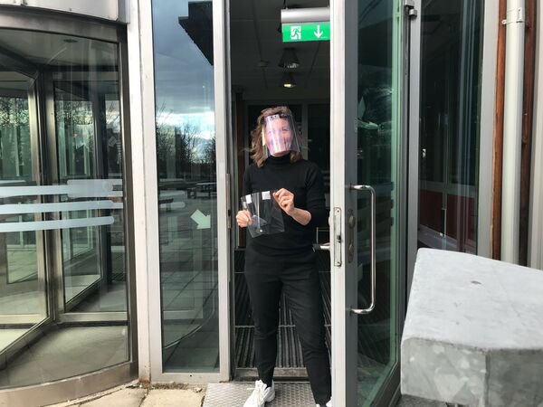 Charlotta Johnsson, showing 3D-printed face shields.