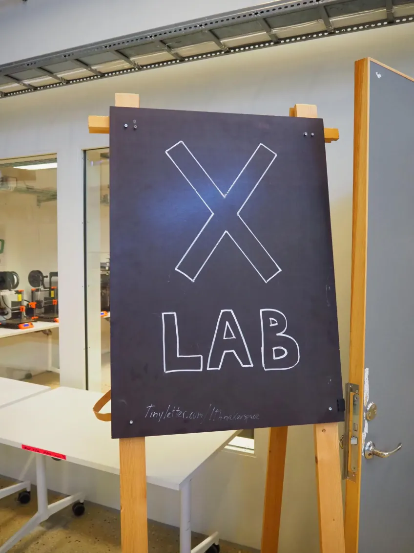 Chalkboard with X Lab written on it. Photo.